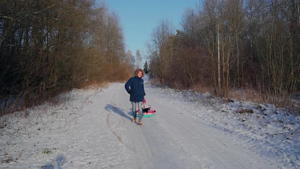 Father and daughter having fun in winter woods outdoors. Two persons spend time together