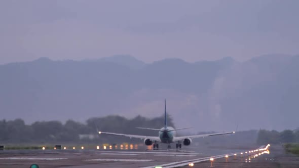 Commercial Airline Take Off From Runway With Mountain View