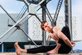 Young man  in the city in the yoga position ardha matsyendrasana stretching  - PhotoDune Item for Sale