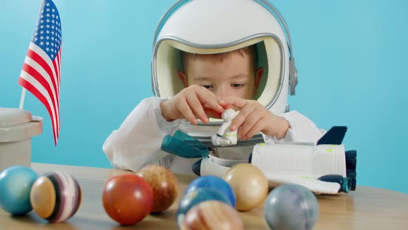 Child Playing at Home Astronaut Little Boy 5 Years Old in Helmet and Astronaut Costume Pilot Sitting