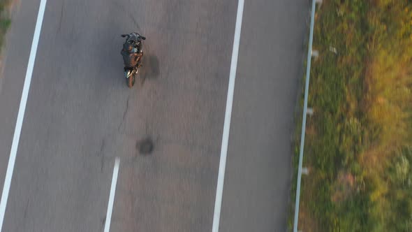 Top View to Biker Driving Motorbike During Road Trip