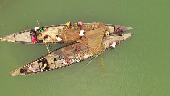 Aerial view of a few fishermen working with a fishing net, Bangladesh.