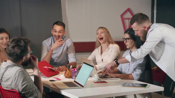 Male and Female Office Workers Are Laughing on Working Meeting