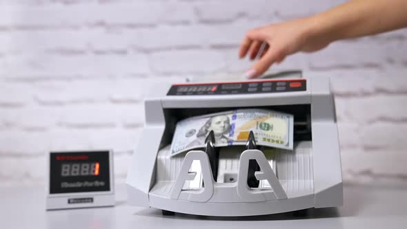 Money counting machine. Modern electronic bill counter with money, close up