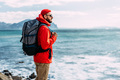 Tourist with a backpack on the background of the sea, rear view. - PhotoDune Item for Sale