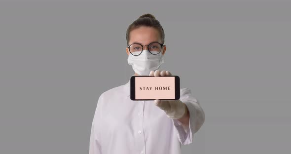 Medical Nurse in Medical Mask, Shows the Sign Saying, Stay Home