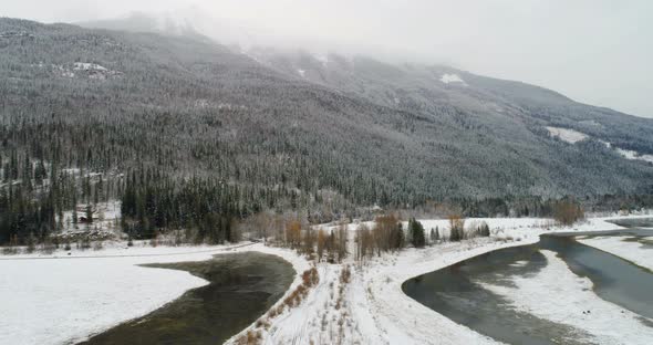 Snow Covered Land and Mountains Along the River 4k