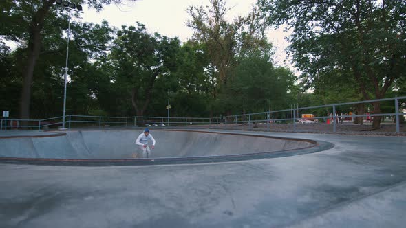 Aggressive Inline Roller Skater Doing Tricks in Concrete Skatepark Outdoors Slow Motion