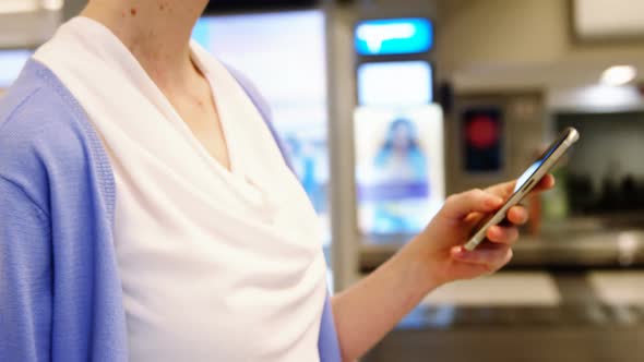 Female passenger using mobile phone