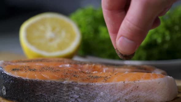 Peppers Slowly Fall Into a Piece of Salmon