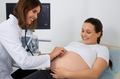 Qualified doctor doing medical check up of pregnant woman - PhotoDune Item for Sale