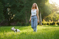 Female dog owner walking with french bulldog in park. - PhotoDune Item for Sale