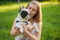 Woman holding purebred french bulldog in park. - PhotoDune Item for Sale