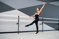 Female dancer training in hall near handrails. - PhotoDune Item for Sale