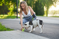 Young woman giving water to dog in park. - PhotoDune Item for Sale
