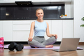 Woman using laptop and dumbbells for training at home - PhotoDune Item for Sale