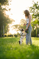 Young woman training french bulldog in park. - PhotoDune Item for Sale