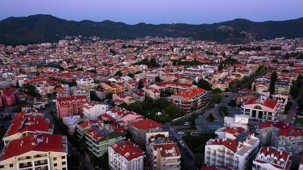 Aerial Drone View Over Red Roof Tiled Buildings on the Background of Mountains