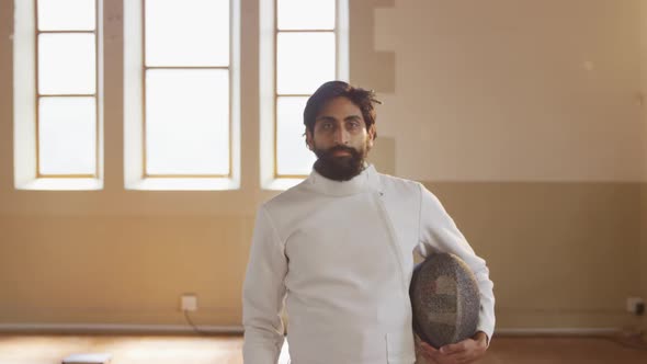 Fencer athlete during a fencing training in a gym