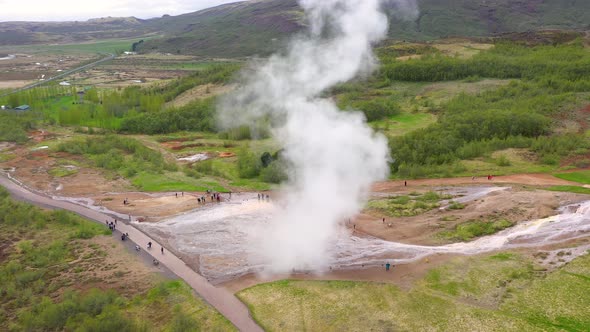 Flying Over Strokkur Geysir, Geyser During Eruption of Water, Iceland, Aerial View