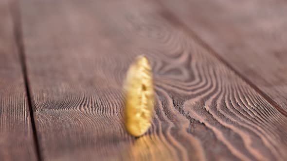 Bitcoin Coin Spinning on Wooden Background  Closeup with Slowmo