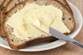 A knife spreading butter on bread - PhotoDune Item for Sale