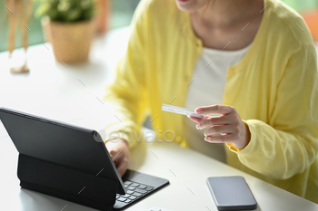  via computer tablet. Online shopping, e-commerce, banking concept.