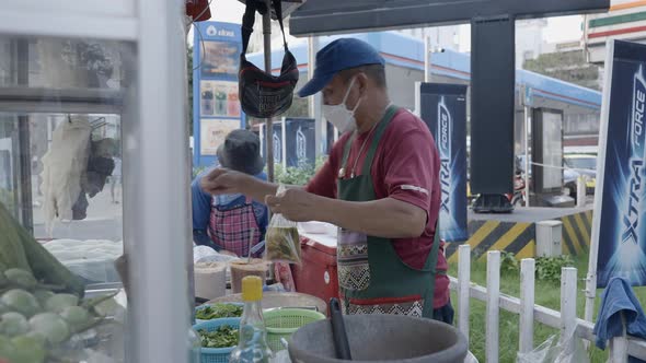 Food Vendor Preparing Take Away Food  Medium Shot