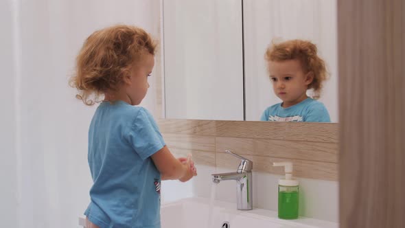 Kid Child Washing Hands in Bathroom