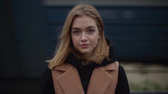 Slow Motion Footage of Young Attractive Woman Standing Against Moving Train Realizing She Missed Her