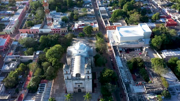 Aerial pull back and camera pitch up locked on the Cathedral de San Gervasio in Valladolid, Yucatan,