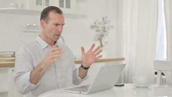 Sad Middle Aged Man Having Failure on Laptop at Home