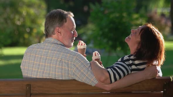 Happy Mature Couple Eating Ice-cream Outdoors