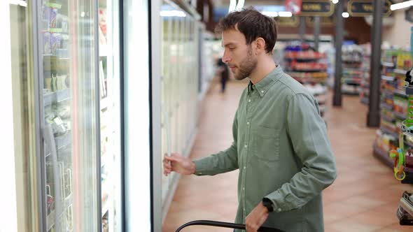 Man Chooses Products in the Supermarket