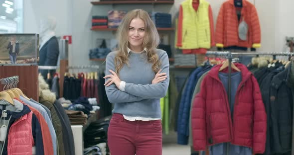 Portrait of Beautiful Young Caucasian Woman Posing in Clothing Shop. Charming Female Shopper