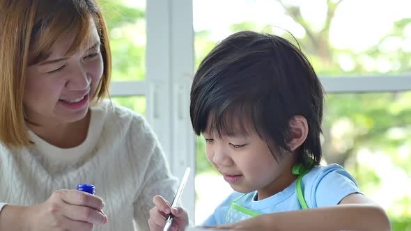 Cute Asian Child And Mother Painting Together