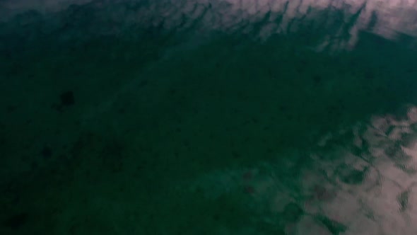 Reflected Water Surface Of Fjord To Rocky Cliffs