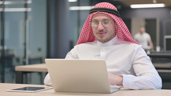 Middle Aged Arab Man Talking on Video Call on Laptop