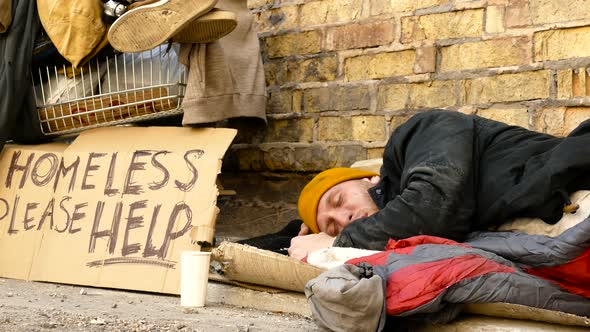 Homeless man sleeping at the street