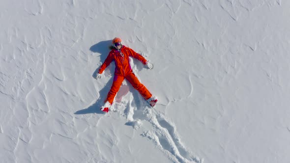 Aerial View Woman in Ski Outfit Laying in Snow