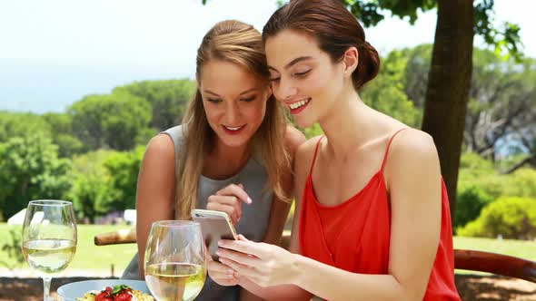 Female friends using mobile phone