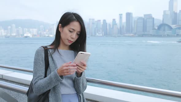 Woman working on mobile phone in Hong Kong