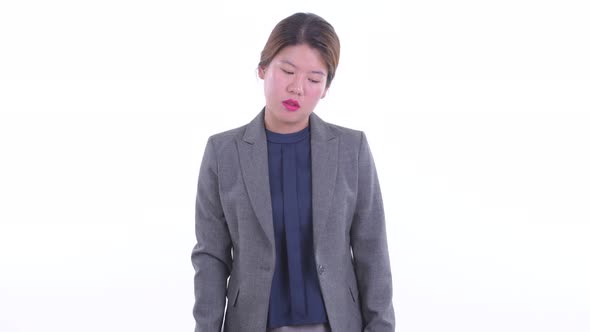 Sad Young Asian Businesswoman Giving Thumbs Down
