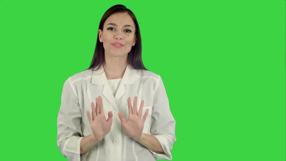 Smiling Young Woman in Lab Coat Talking To the Camera on a Green Screen