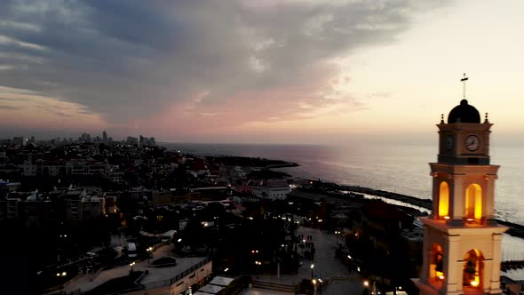 Epic drone shot of the clock tower in Jaffo Tel Aviv at sunset 4K