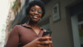 Cheerful African woman in glasses holding smartphone on the stre - PhotoDune Item for Sale