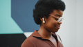 Side view of Afro woman in glasses listening to music wearing wi - PhotoDune Item for Sale
