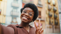 Positive African American dark haired woman taking selfie on str - PhotoDune Item for Sale