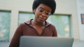 Afro haired woman in glasses working on laptop. Female student s - PhotoDune Item for Sale