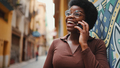 Portrait of Afro female talking over mobile phone. Cheerful Afri - PhotoDune Item for Sale